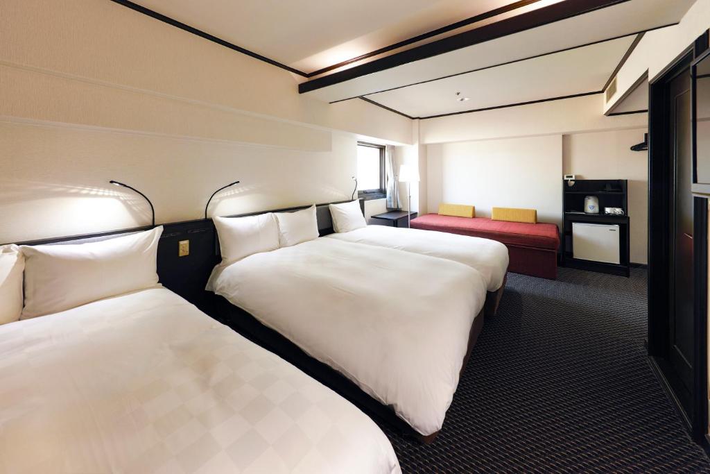 Postel nebo postele na pokoji v ubytování Hotel Consort Shin-Osaka