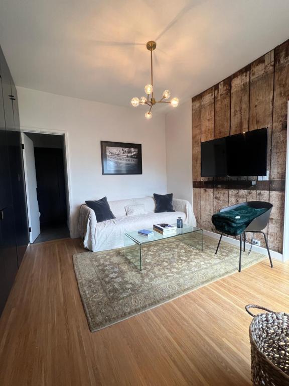 a living room with a couch and a glass table at Charming 2BR Cottage with Bay and City Views-Gated Luxury Private Place in San Francisco