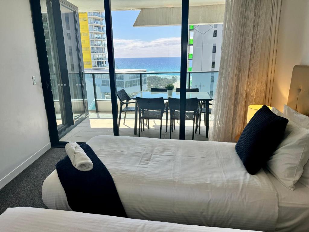 a bedroom with a bed and a view of the ocean at Oracle 11th floor Tower 1 - GC Getaways in Gold Coast