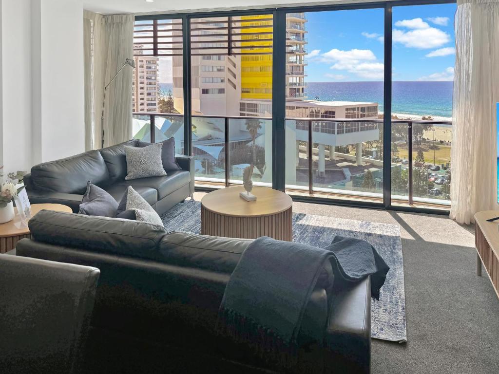 a living room with a couch and a view of the ocean at Oracle 11th floor Tower 1 - GC Getaways in Gold Coast
