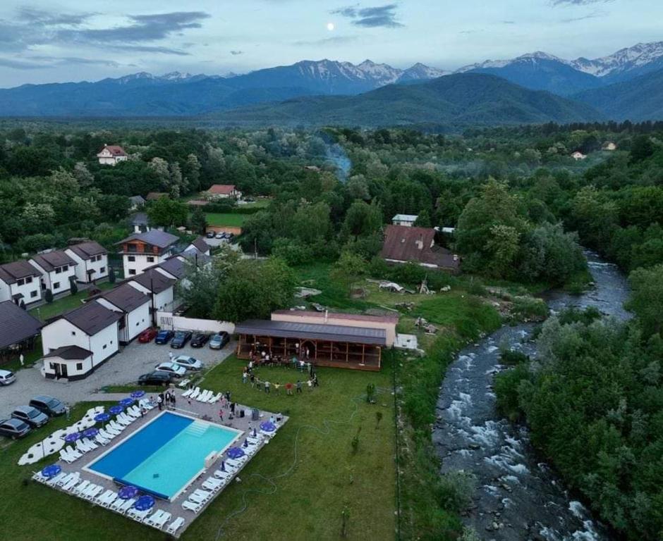 an aerial view of a resort with a pool and a river at Domeniul Roa in Avrig