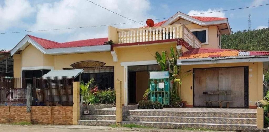 a house with a red roof at Cody Homestay in Burgos