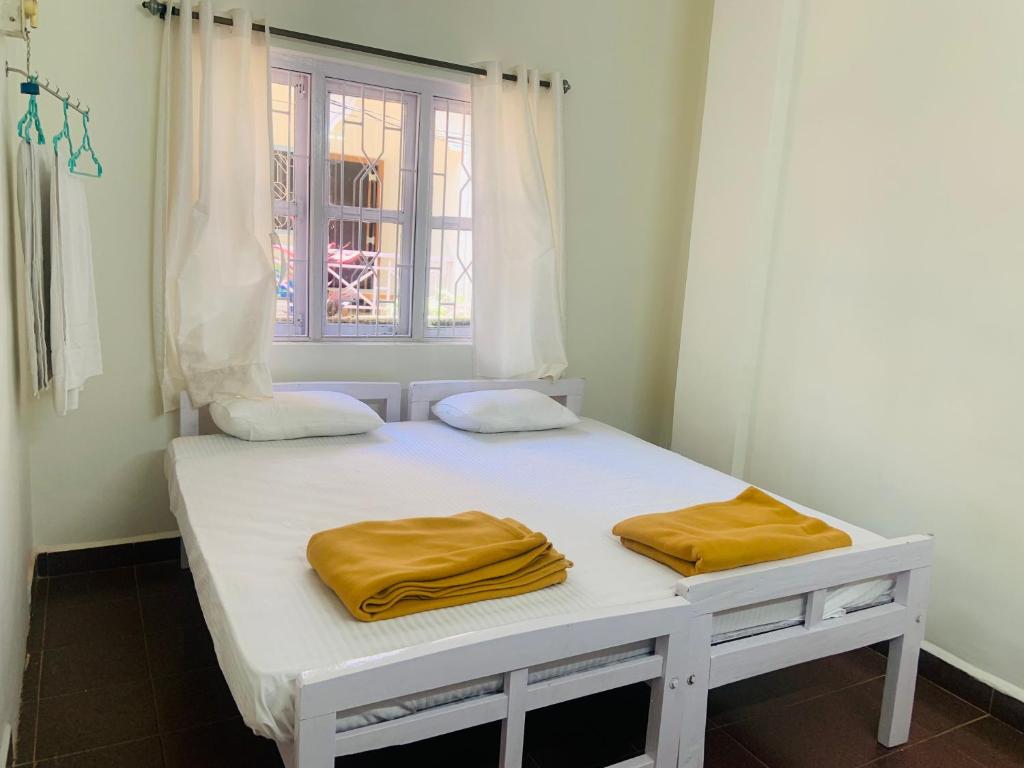 Postel nebo postele na pokoji v ubytování Palolem Paradise Guest House
