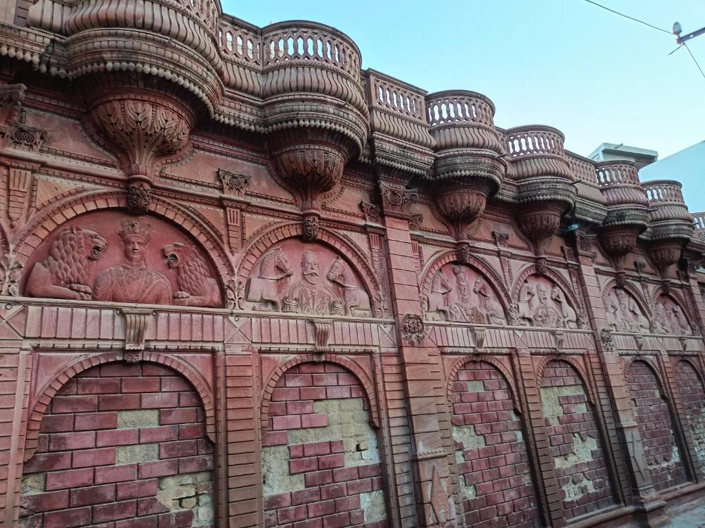 a building with statues on the side of it at Rose Merry Guesthouse in Bikaner