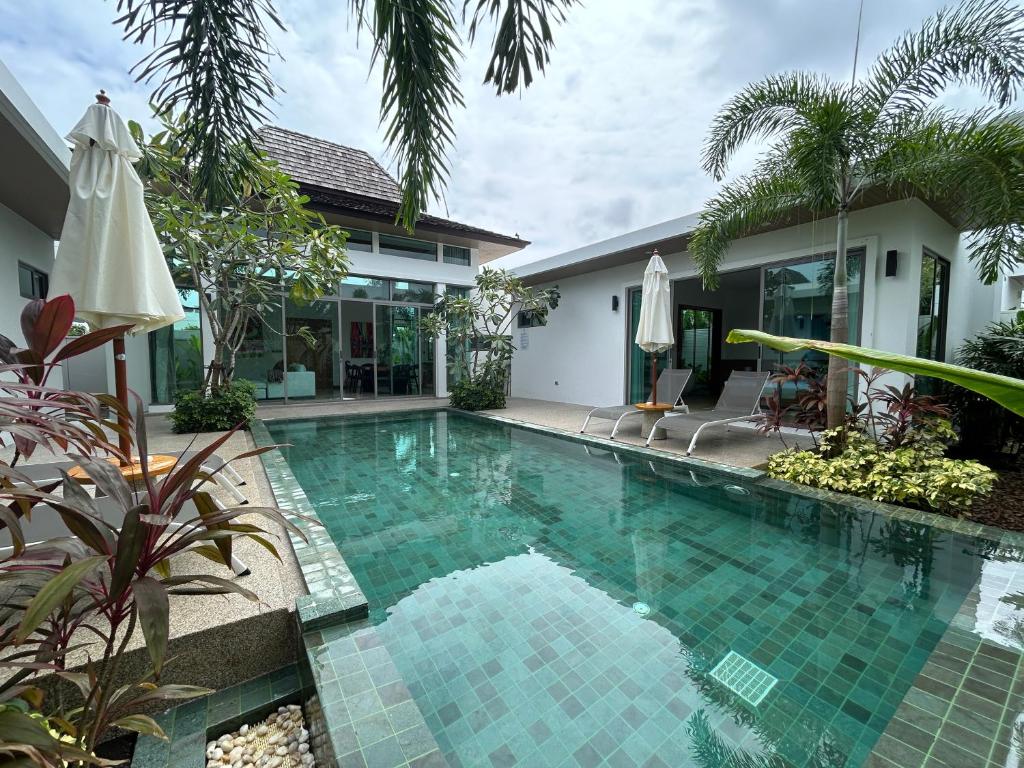 a swimming pool in front of a villa at Lada Pool Villa in Bang Tao Beach