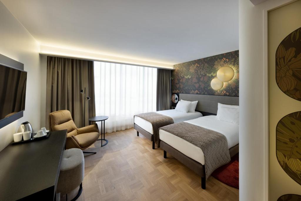 Postel nebo postele na pokoji v ubytování Nordic Hotel Forum