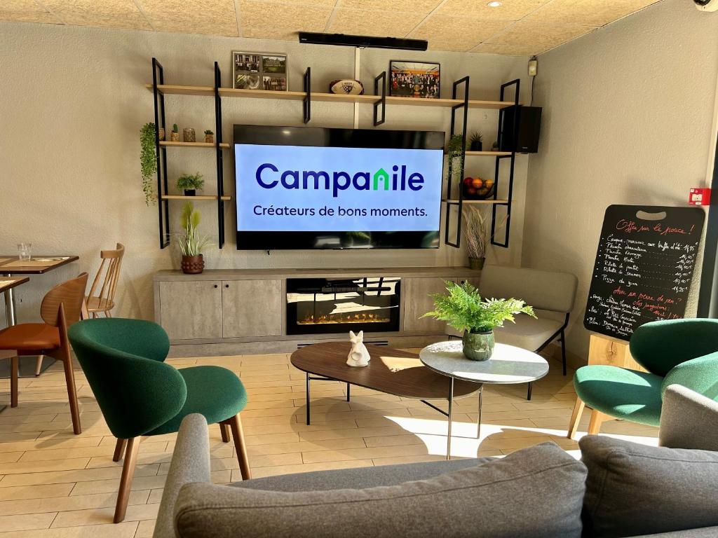 a living room with a tv and a fireplace at Campanile NATURE - Bordeaux Sud Pessac in Pessac