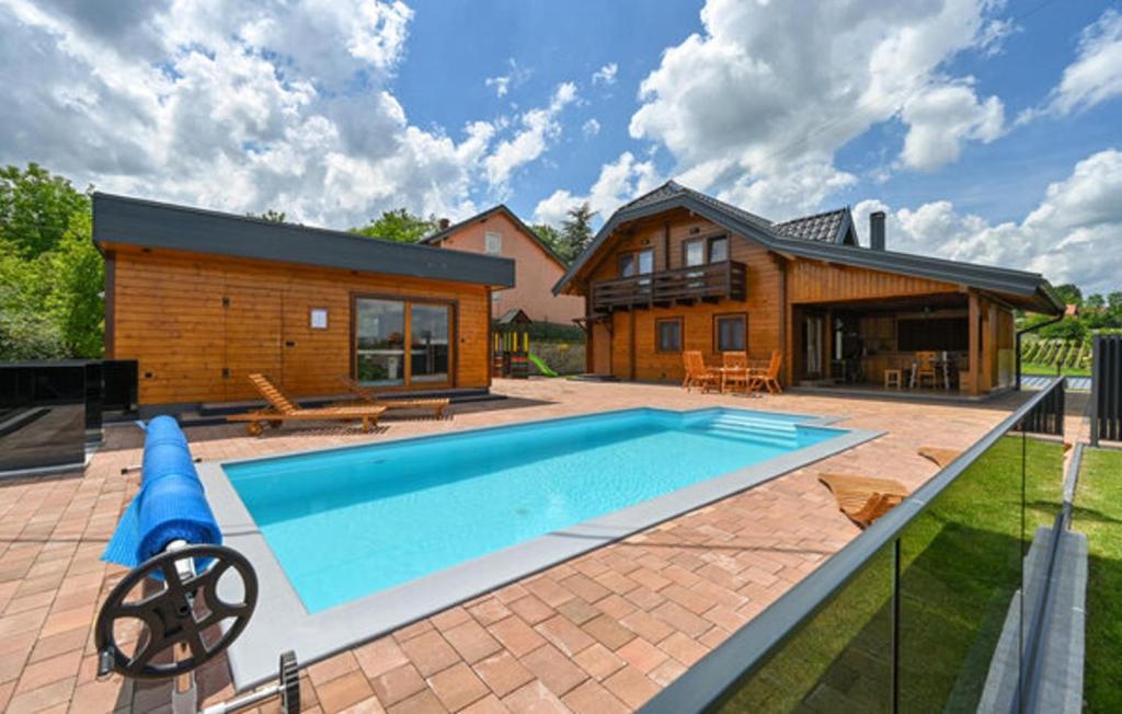 a house with a swimming pool in front of a house at Vineyard Dream Villa in Vinogradi Ludbreski in Vinogradi Ludbreški