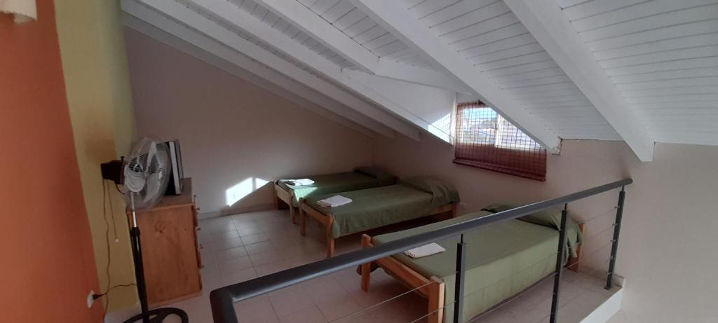 an attic room with a couch and a window at Refugio de mar Bahia Creek in Las Grutas