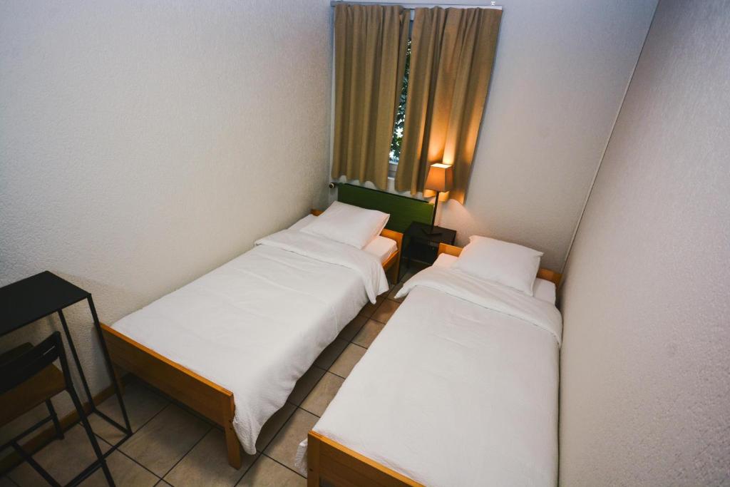 Ένα ή περισσότερα κρεβάτια σε δωμάτιο στο Alaïa Hostel
