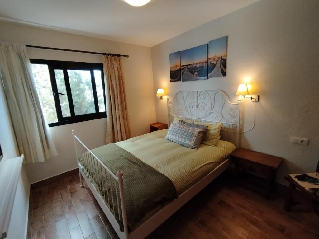 a bedroom with a bed with a white bed frame at Casa Sauce in Puerto del Carmen