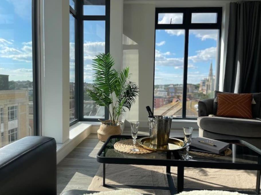 a living room with a couch and a table at THE PAD by the beach Penthouse apartment with sunset and city views in Bournemouth