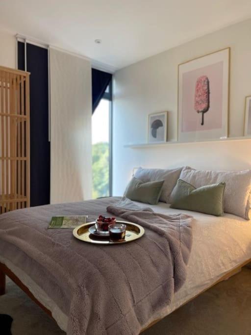 a bed with a plate of food on top of it at THE PAD by the beach Penthouse apartment with sunset and city views in Bournemouth