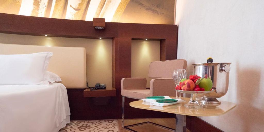 A bed or beds in a room at Risorgimento Resort