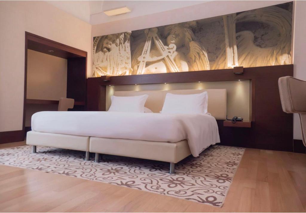 A bed or beds in a room at Risorgimento Resort