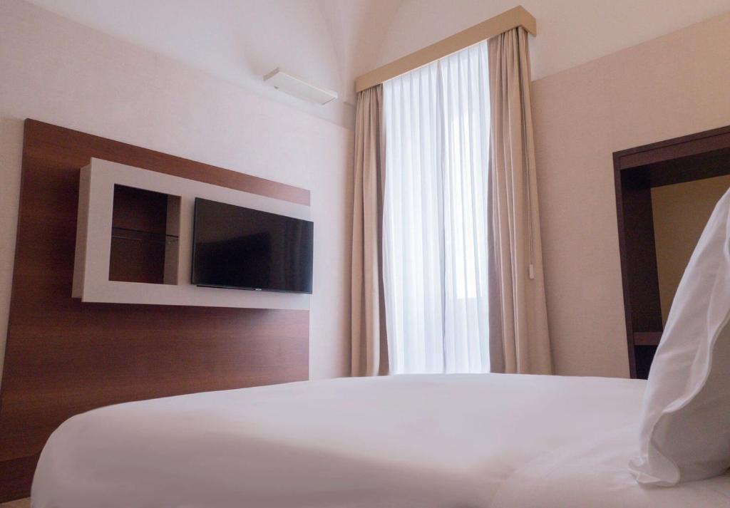A bed or beds in a room at Risorgimento Resort