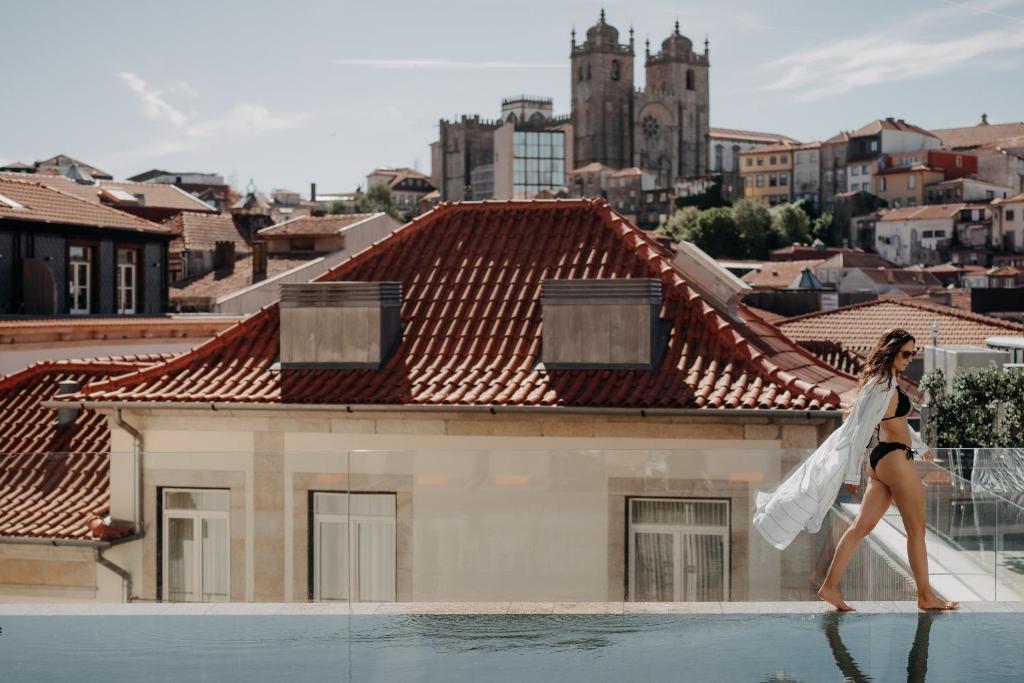 a woman walking on the roof of a building at Casa da Companhia, Vignette Collection by IHG in Porto