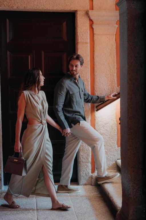 a man and a woman standing in front of a door at Casa da Companhia, Vignette Collection by IHG in Porto