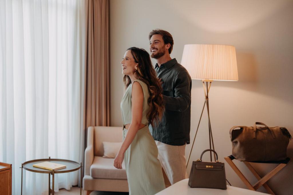 a man and a woman standing in a hotel room at Casa da Companhia, Vignette Collection by IHG in Porto