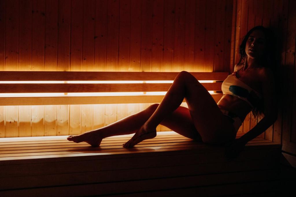 a woman sitting in a room in a wooden wall at Casa da Companhia, Vignette Collection by IHG in Porto
