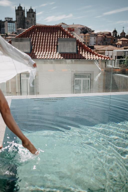a person is standing in a swimming pool at Casa da Companhia, Vignette Collection by IHG in Porto