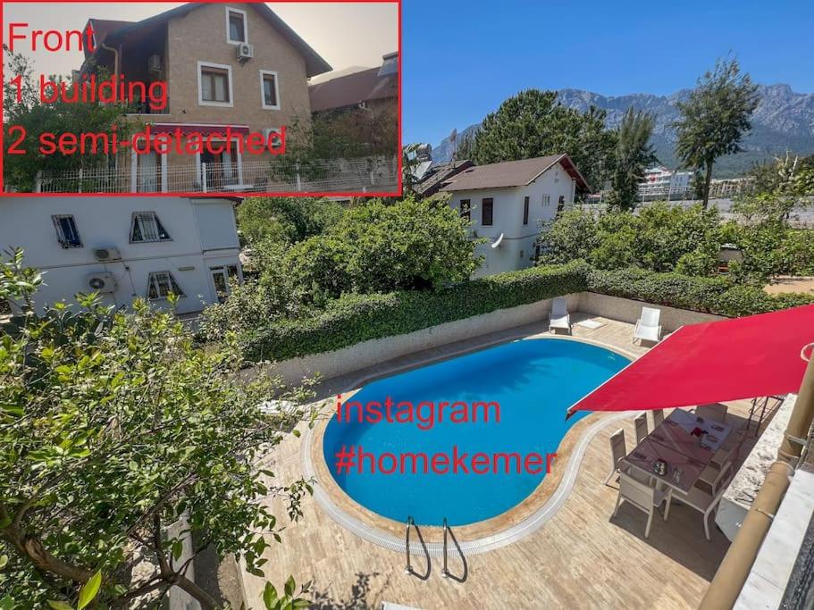 a picture of a swimming pool with a red umbrella at Homekemer A in Kemer