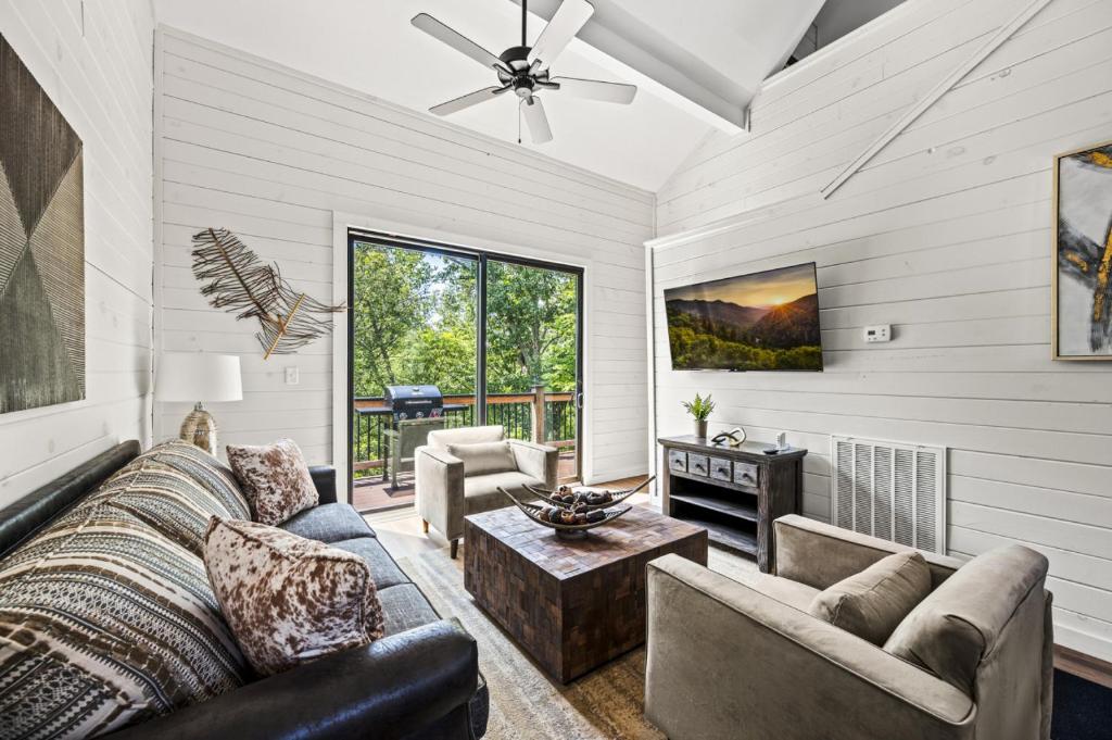 un salon avec un canapé et une table dans l'établissement Pine Ridge Retreat w Hot Tub Grill Games More, à Dandridge