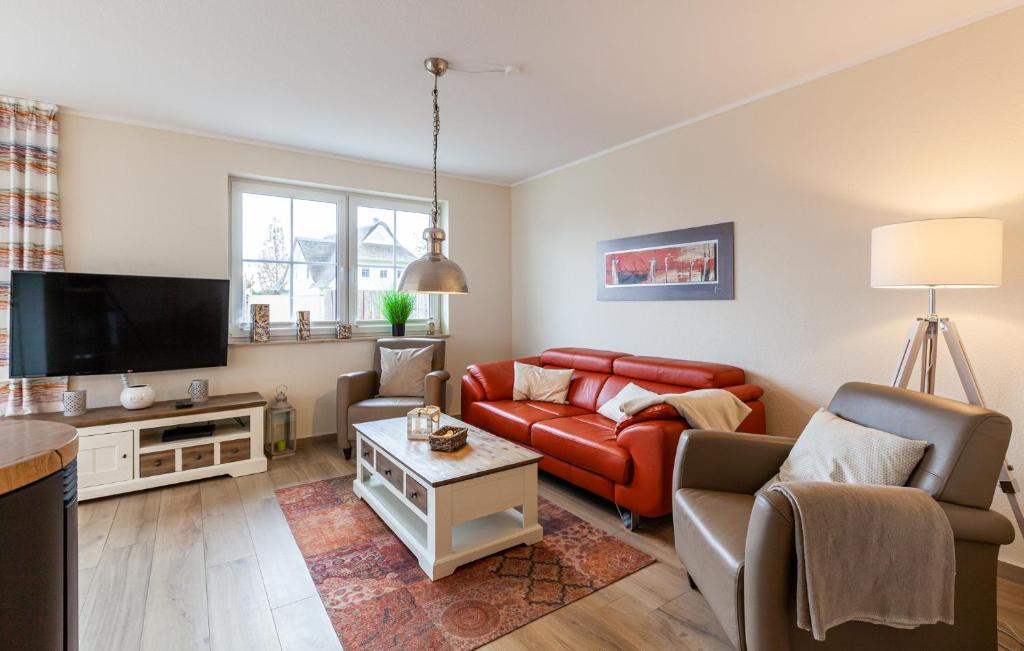 a living room with a couch and a tv at Seeteufel in Zingst