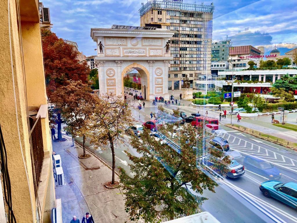 an arch in a city with cars on a street at Stay in Skopje - Prime Location Apartment in Skopje