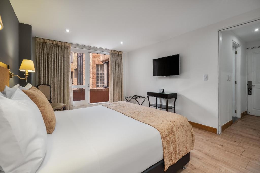 Postel nebo postele na pokoji v ubytování Hotel Le Manoir Bogotá