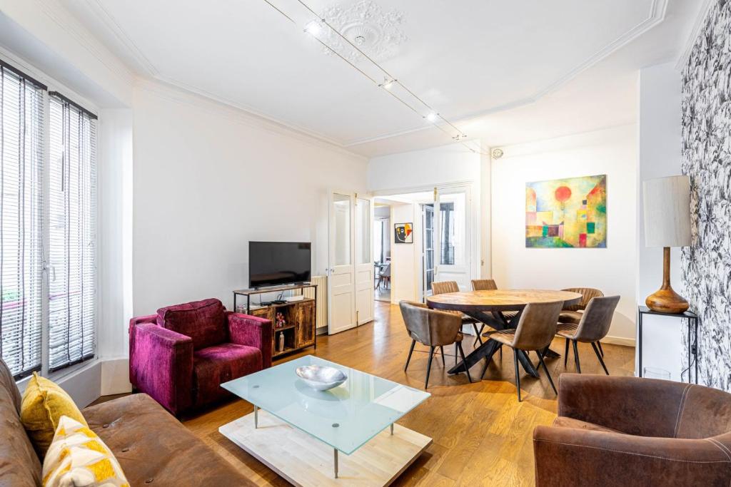 un salon avec un canapé et une table dans l'établissement GuestReady - Spacieux Appartement idéal pour 6, à Paris