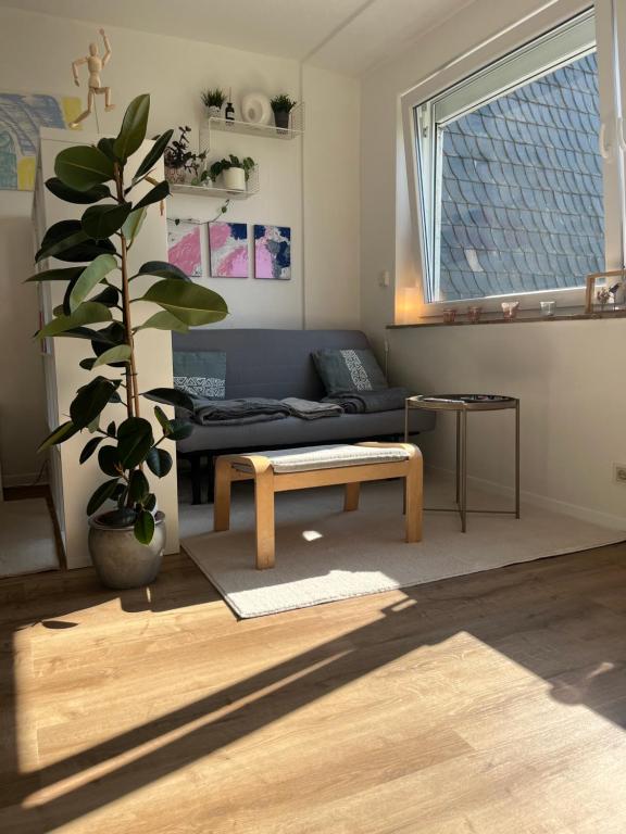 a living room with a couch and a table at Schönes Apartment mit Balkon Aggertalsperre in Bergneustadt