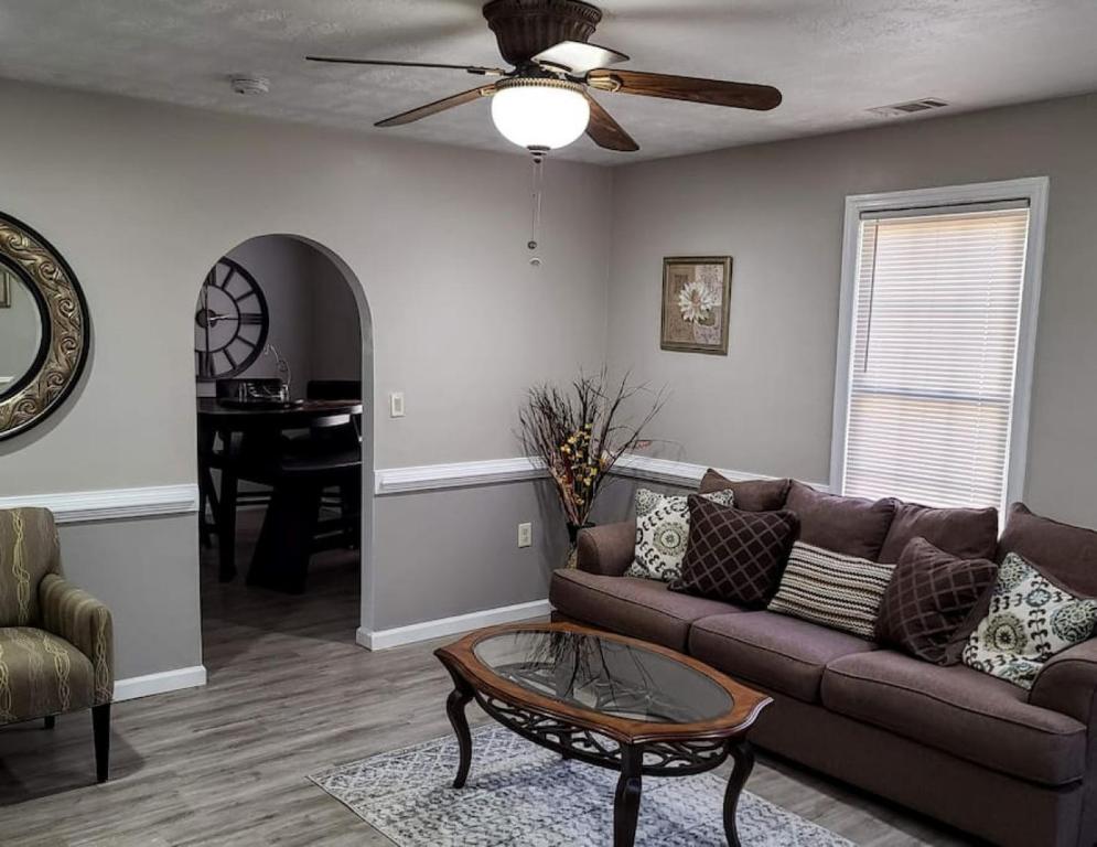 ein Wohnzimmer mit Sofa und Tisch in der Unterkunft Cozy, Contemporary Haven Near Historic Downtown in Savannah