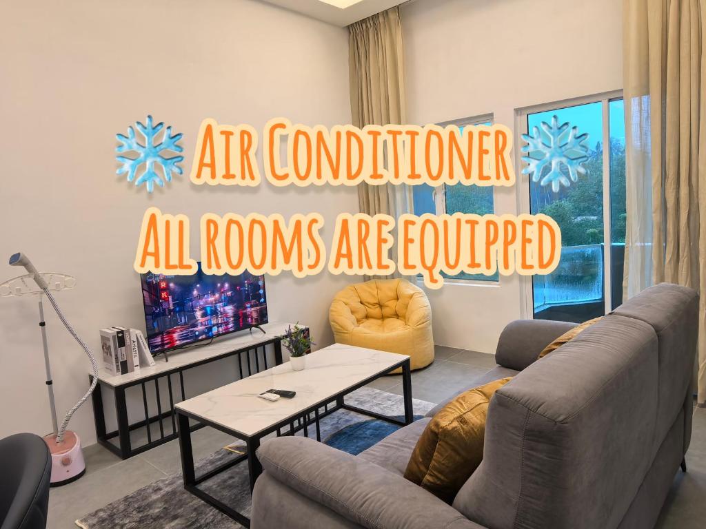 an air conditioned living room with a couch and a table at Langkawi Simfoni Cassia Suite 04 9pax in Kuah