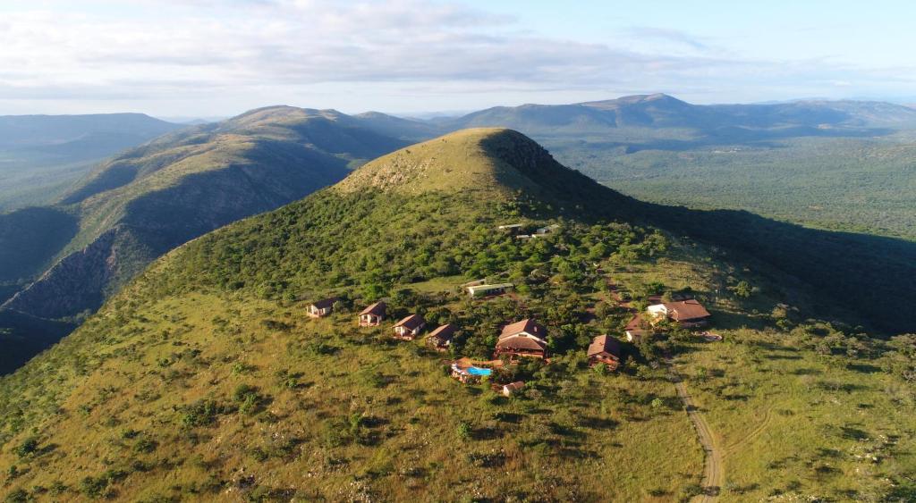an aerial view of a mountain with houses on it at Pakamisa Private Game Reserve in Pongola
