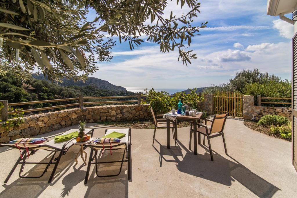 a patio with tables and chairs and a view at Christos Place-Anidri in Palaiochora