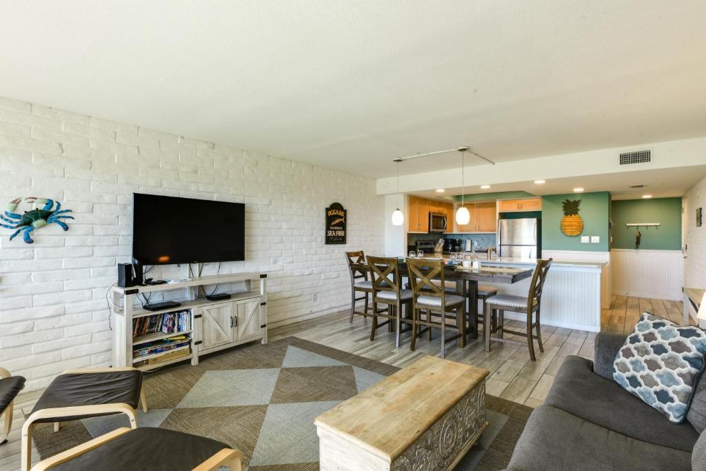 a living room with a couch and a table at Direct Beach Access Sunny Port Aransas Condo in Port Aransas