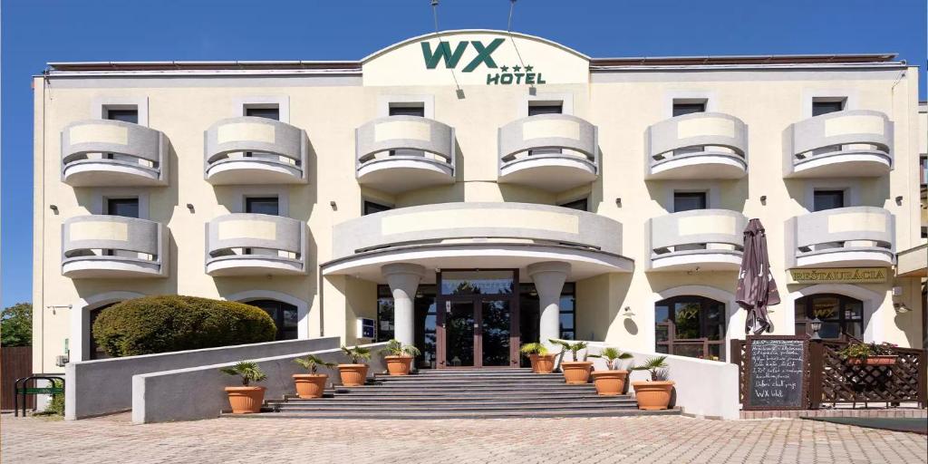 a large white building with balconies on it at WX Hotel in Bratislava