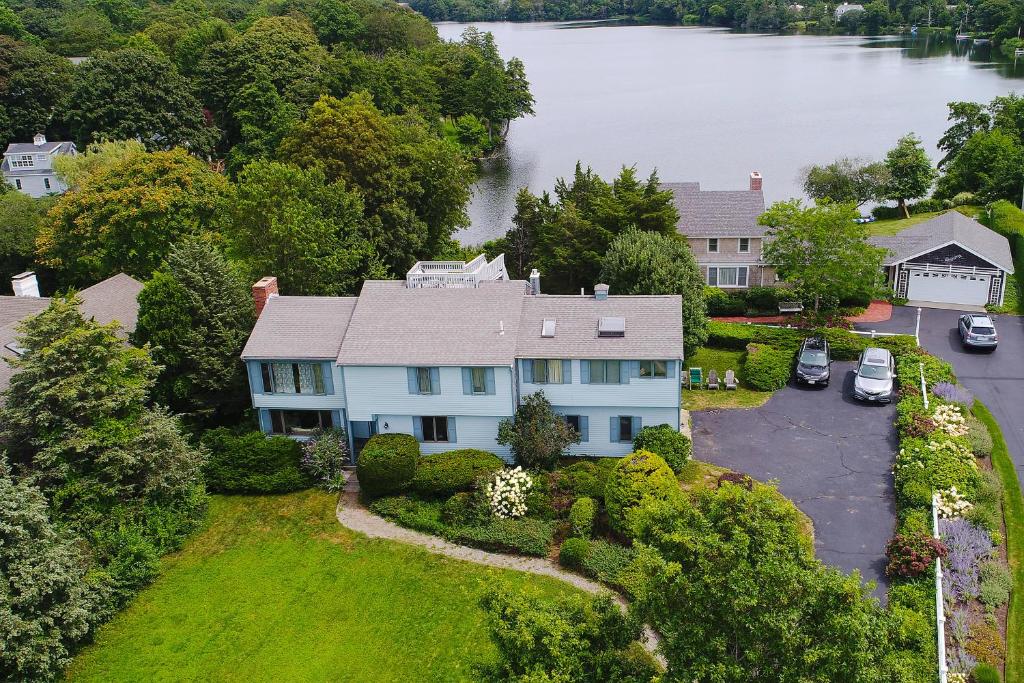 an aerial view of a house with a lake at Mill View: La Maison de l'Artiste in Falmouth