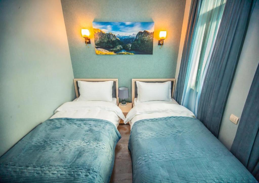 Postel nebo postele na pokoji v ubytování MUSMORE Boutique Hotel