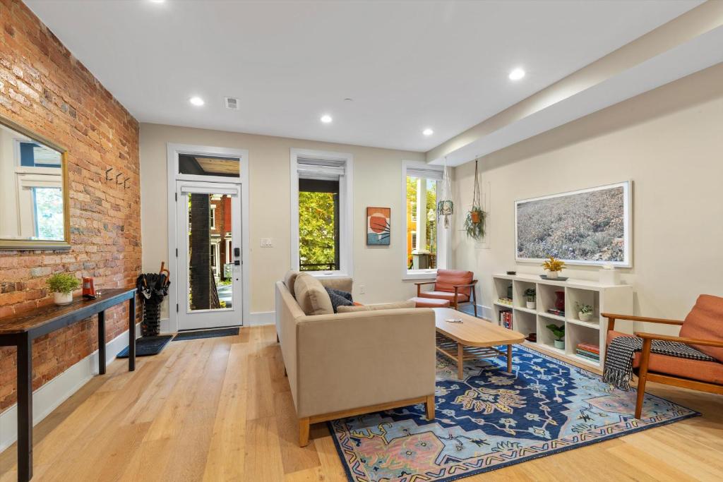 a living room with a couch and a table at Central DC 5-BR Townhome - Walk to METRO-rail in Washington, D.C.