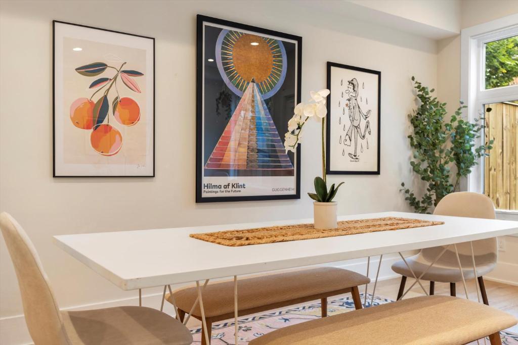 a dining room with a white table and chairs at Central DC 5-BR Townhome - Walk to METRO-rail in Washington, D.C.