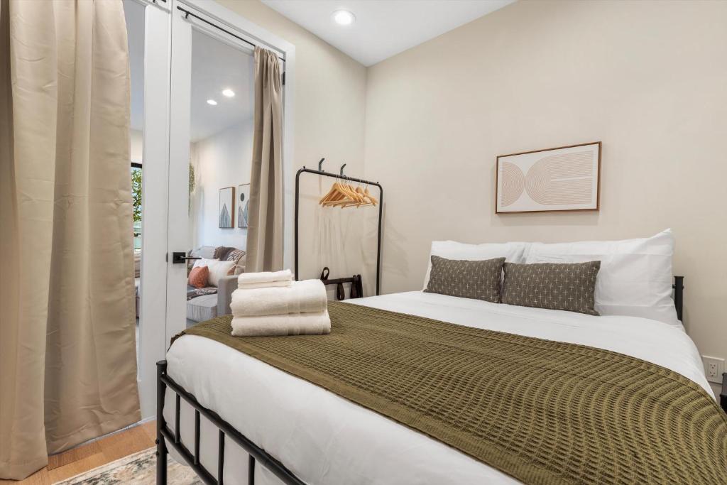a bedroom with a large bed and a window at Central DC 5-BR Townhome - Walk to METRO-rail in Washington, D.C.