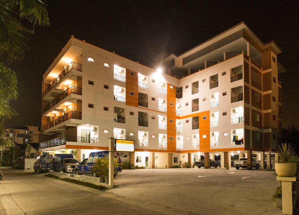 a building with cars parked in front of it at night at V at Bangsaen in Bangsaen