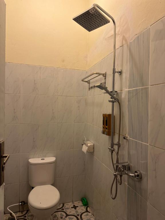 a bathroom with a toilet and a shower at Little Bali Villa - Luxury Lake View at Bogor in Kalisuren 2