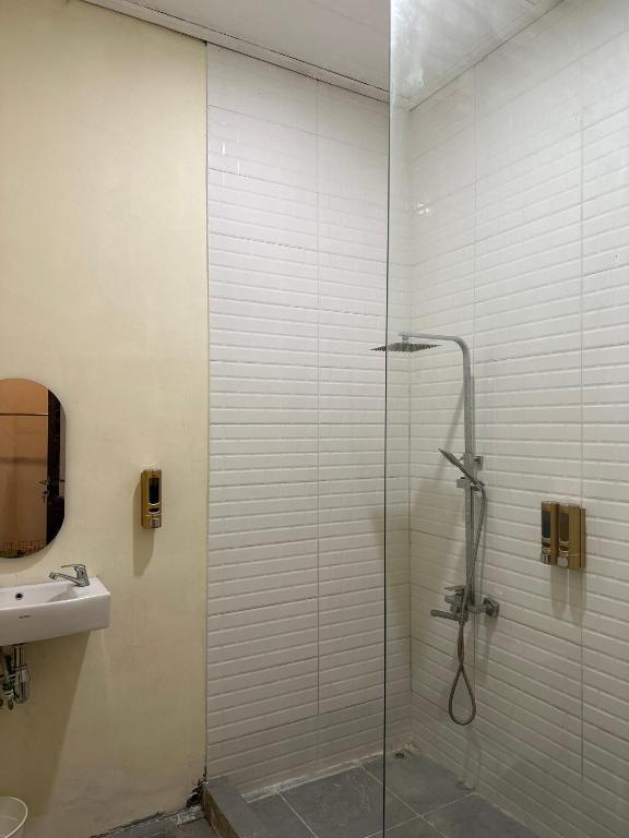 a bathroom with a glass shower and a sink at Little Bali Villa - Luxury Lake View at Bogor in Kalisuren 2