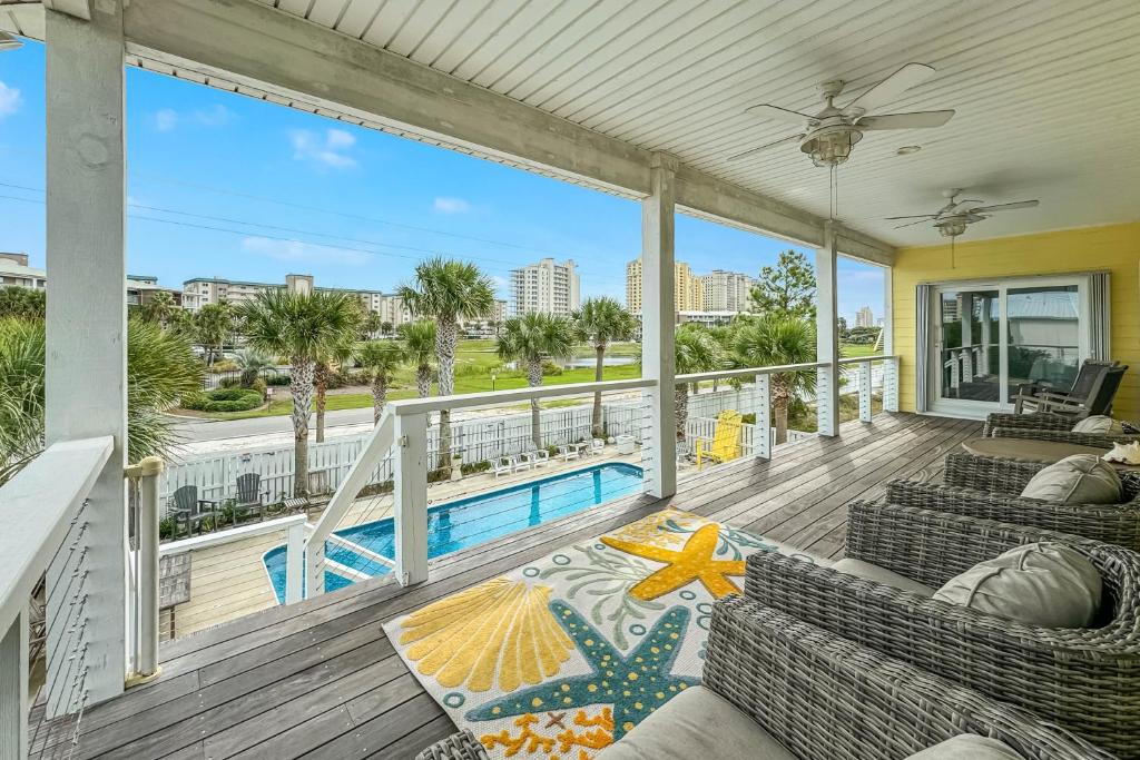 a balcony with two couches and a swimming pool at The Yellow House North at Herons Walk in Pensacola