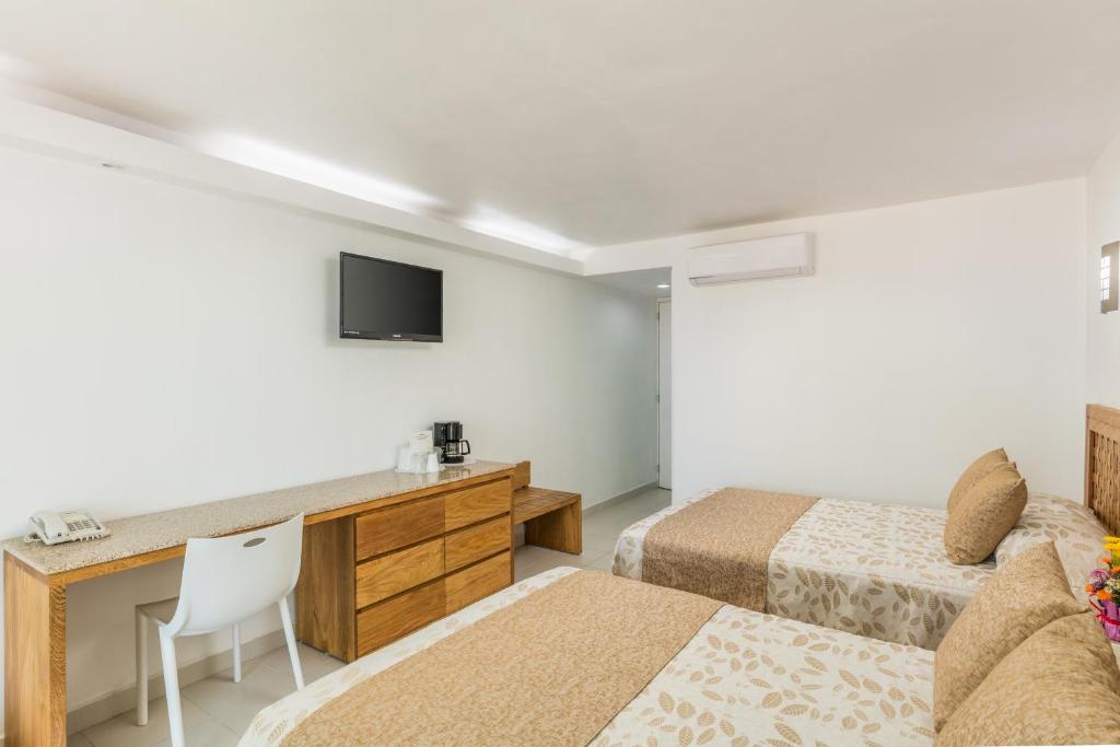 Postel nebo postele na pokoji v ubytování Posada Real Ixtapa