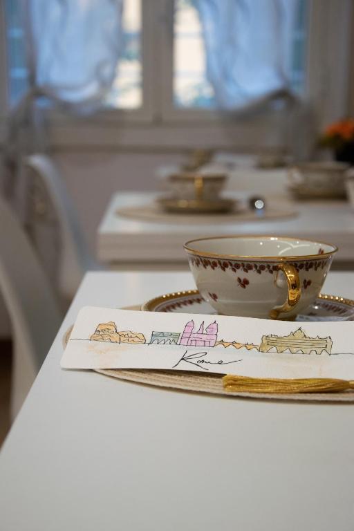 a cup and a napkin on a table with a cup and a plate at MBS Marconi Bridge Suites Guest House in Rome