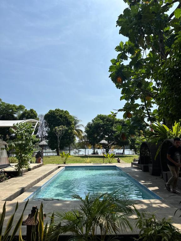a swimming pool in the middle of a garden at Little Bali Villa - Luxury Lake View at Bogor in Kalisuren 2